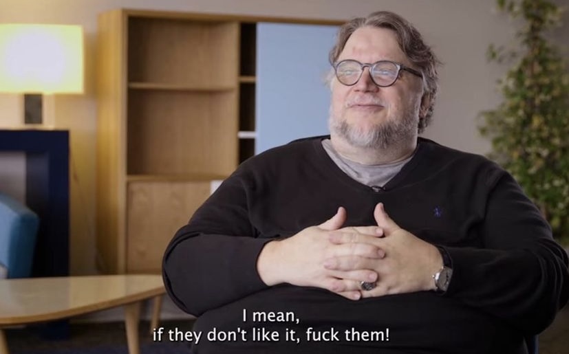 A screenshot an interview with director and artist Guillermo Del Toro. There are subtitles embedded in the image that quote Del Toro saying, “I mean, if they don’t like it, fuck them!”